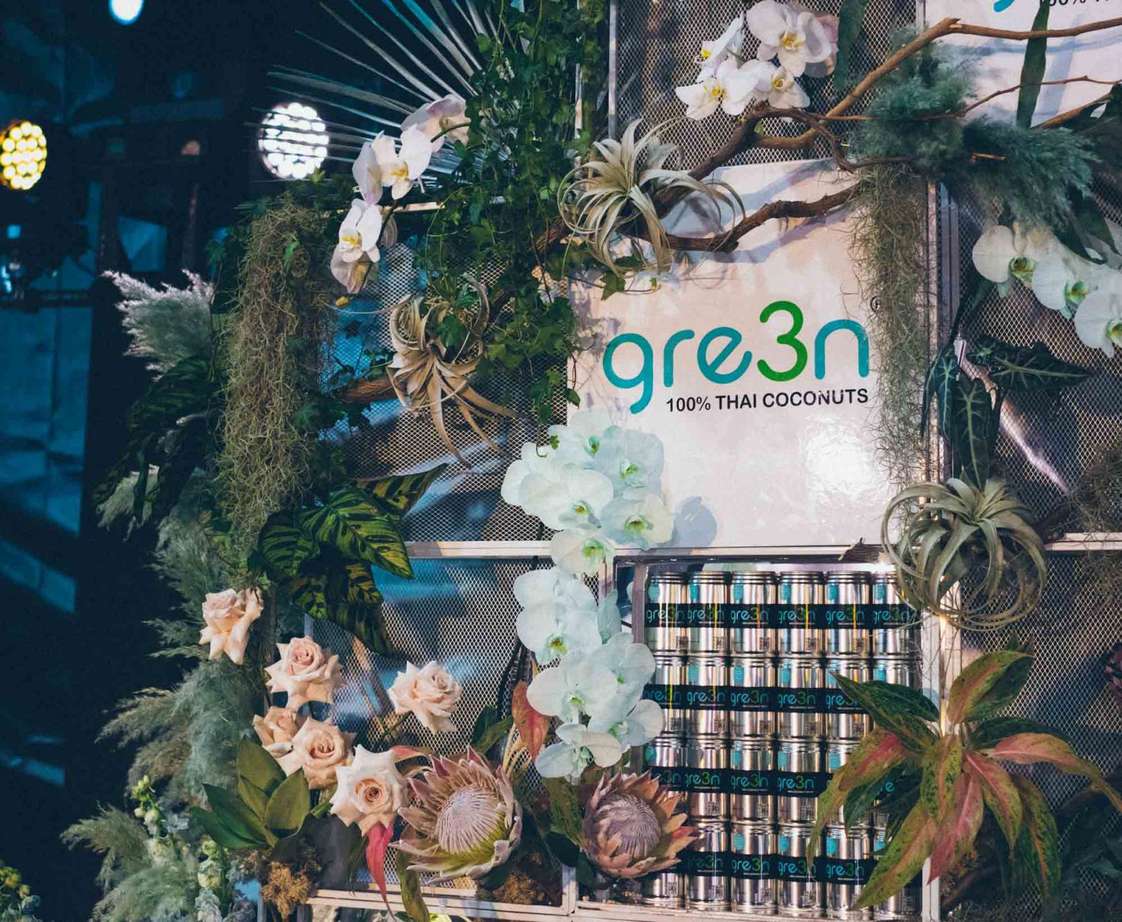 Floral wall product display with tropical plants and flowers